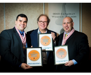 (Left) David Weaver and (right) Bill Atwood of Corby Distillers accept their award for Corby's Lot No. 40 from Davin de Kergommeaux at the Canadian Whisky Awards.