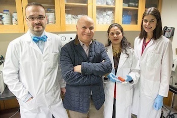 Philip Demokritou (in blue coat) with his lab team, from left: Georgios Pyrgiotakis, Pallavi Vedantam, and Caroline Cirenza. Photo from Harvard T.H. Chan School of Public Health website.