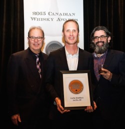 Dr. Don Livermore of Corby Distillers (centre) accepts the award for Canadian Whisky of the Year from Davin de Kergommeaux (left) and renowned whisky author Dave Broom (right). (PRNewsFoto/Canadian Whisky Awards)
